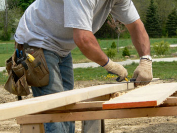 Handyman Measuring to Prepare lumber to cut
