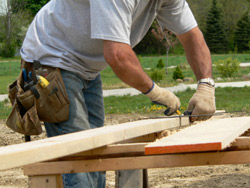 Carpenter measuring for remodeling job