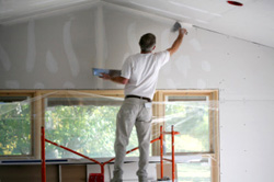 Handyman applying mud to Drywall seams