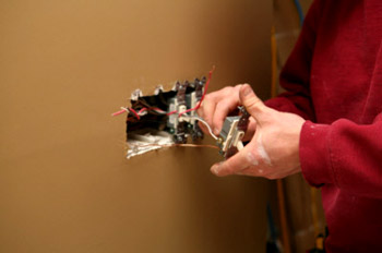 Electrician installing a light switch.